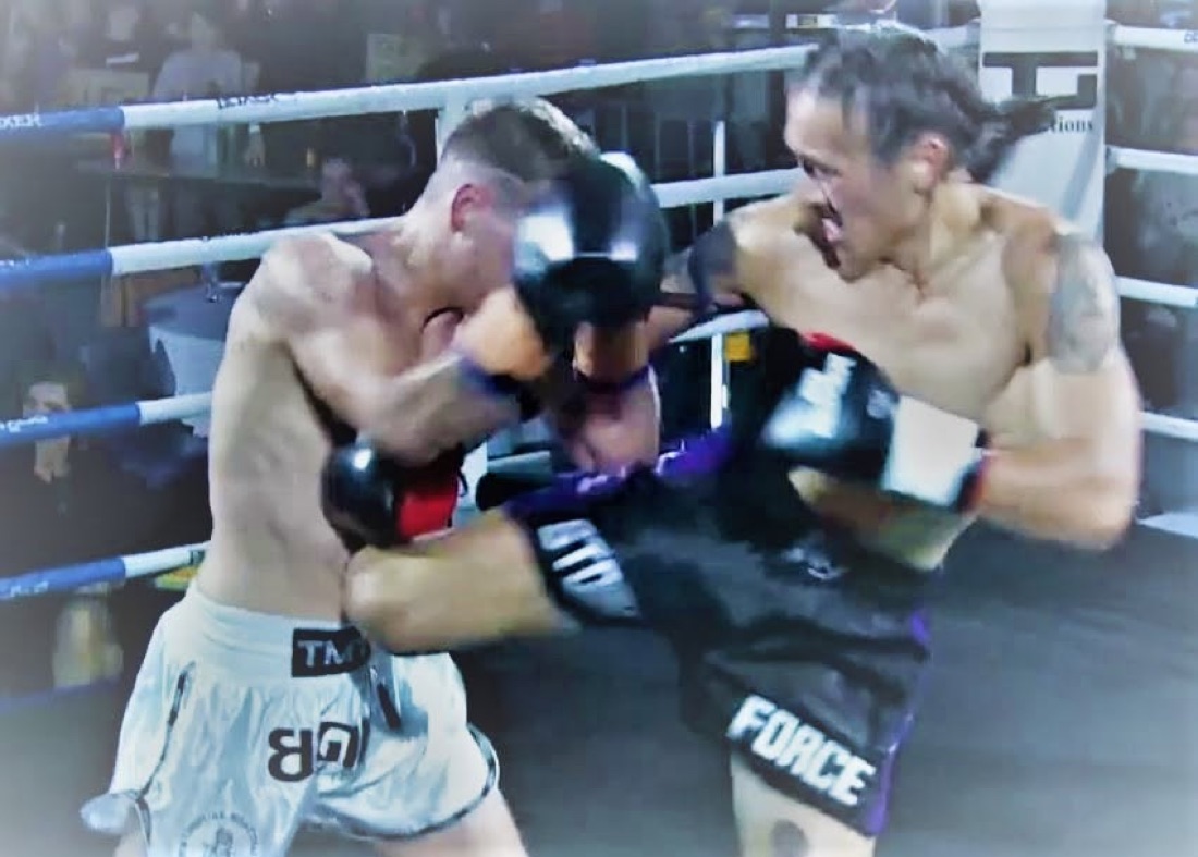 Two kickboxers exchanging strikes during a ring bout